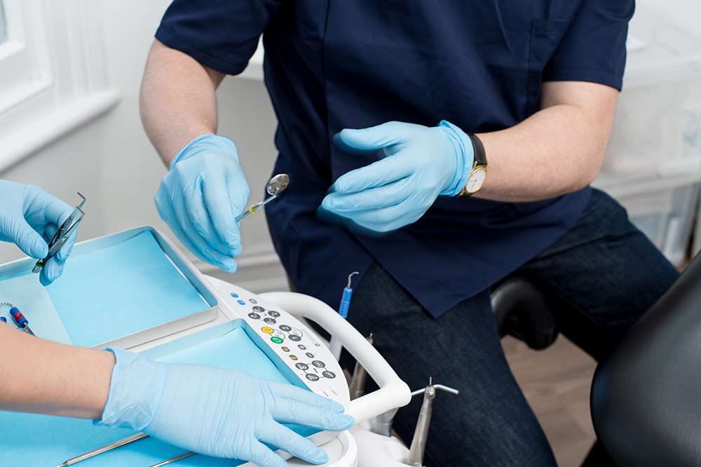 Cropped image of male dentist with tools
